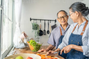 Older couple chopping vegetables
