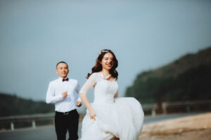 Bride and groom running happily