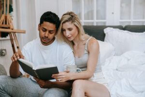 a mixed couple reading together