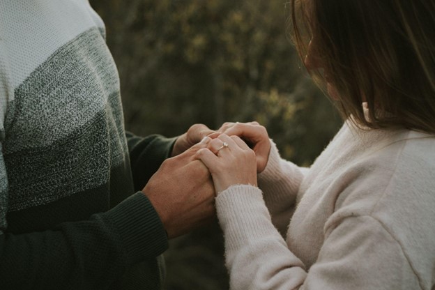 an engaged couple holding hands