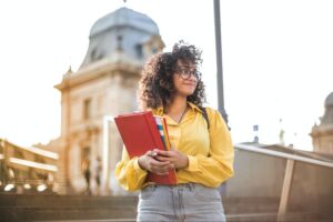 an ethnic woman holding books