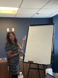 woman presenting using a whiteboard