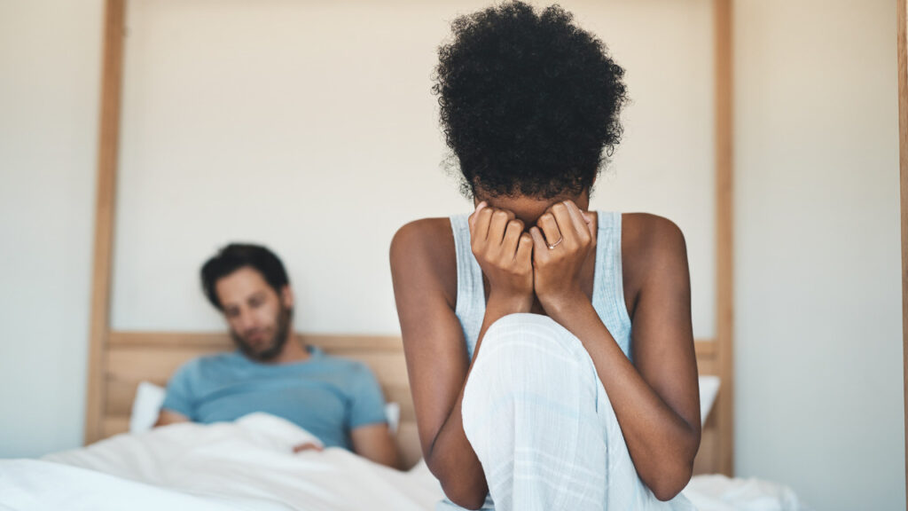 woman crying beside her partner