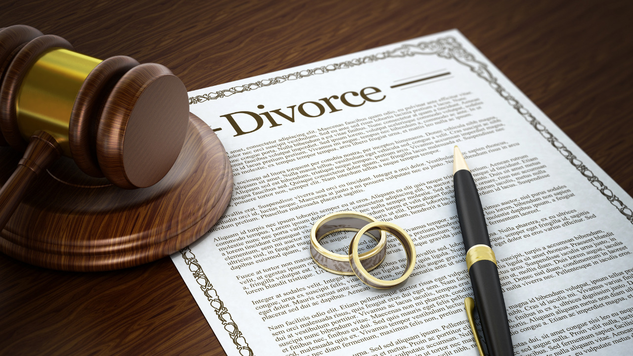 divorce paper with couple ring , pen, and judge gavel