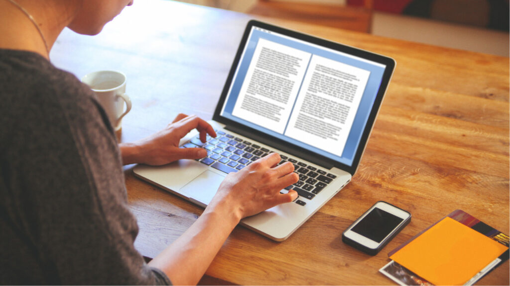 a woman reading articles on her laptop