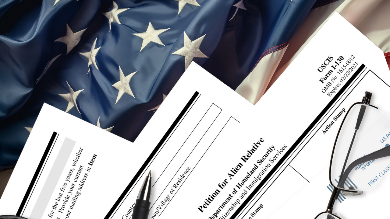  I-130 petition form with pen and eyeglasses